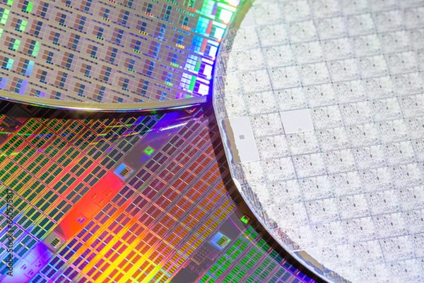 Fototapeta A pattern of microprocessor circuits on a silicon wafer. The semiconductors or central processing unit CPU microchips are fabricated from a silicon wafer with patterned layers of various materials.