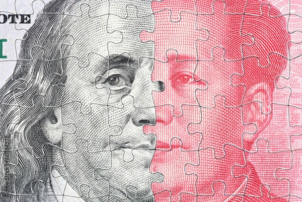 Fototapeta A complex jigsaw puzzle featuring faces of Benjamin Franklin and Mao Zedong symbolizes the intricate trade war conflict and tension between USA and China, specifically in the realm of semiconductor.