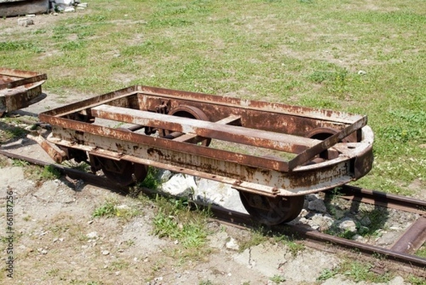Fototapeta A rusty platform of a narrow-gauge railway carriage