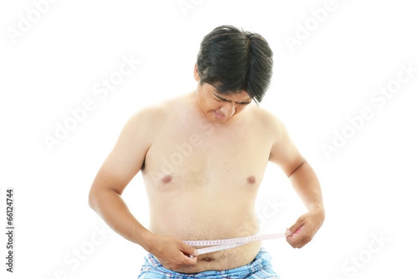 Fototapeta 腹囲を測定する肥満気味の男性