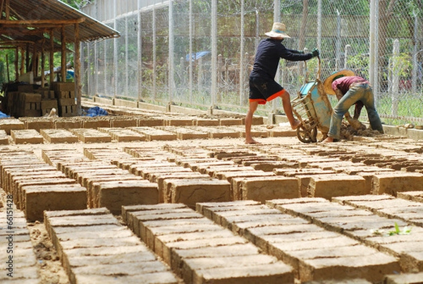 Obraz Two men making a lot of soil bricks
