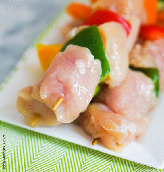 Fototapeta raw chicken kebabs with baked potatoes
