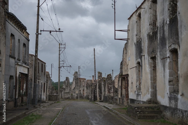 Fototapeta View of the unfortunate little town destroyed during the war, some facades remain on the main street, it is a cloudy, rainy and gray day