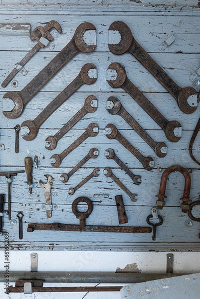 Fototapeta Old shed containing rusty mechanical tools. Vintage old tools with rust