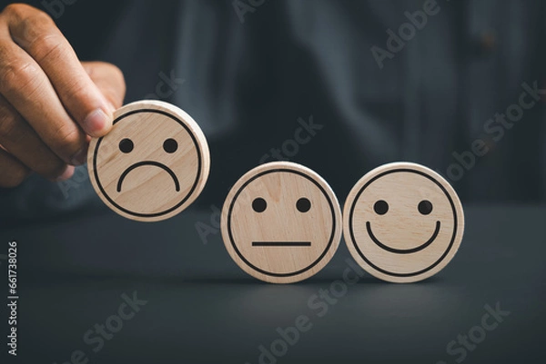 Fototapeta Customer dissatisfaction concept. customer holds frown icon on wooden circle, symbolizing poor satisfaction. Depicting an unhappy customer, negative feedback, and disappointment.