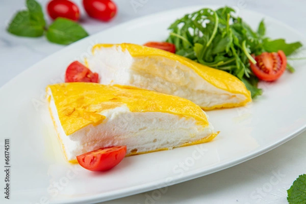 Obraz French tall omelette with arugula and cherry tomatoes side view