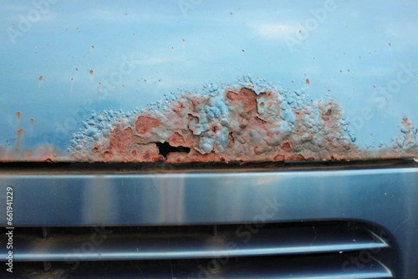 Fototapeta Close up of penetrating rust on a blue bonnet from an old disused car