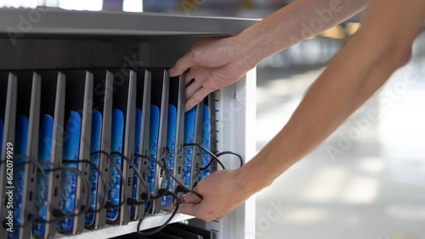 Fototapeta Computers connected and charging ready to use.