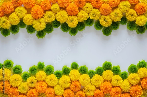 Fototapeta Decorative rangoli made from colorful marigold flowers and green Chrysanthemum for Diwali festival on white background with space for text.