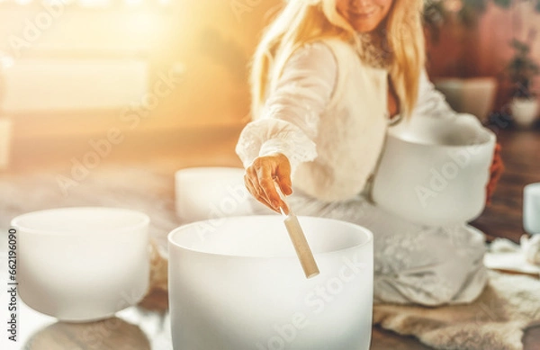 Obraz Woman playing on a crystal bowl. Ceremony space.