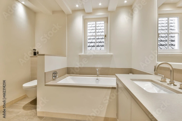 Obraz a bathroom with two sinks and a bathtub next to the tub in front of the sink is an open window