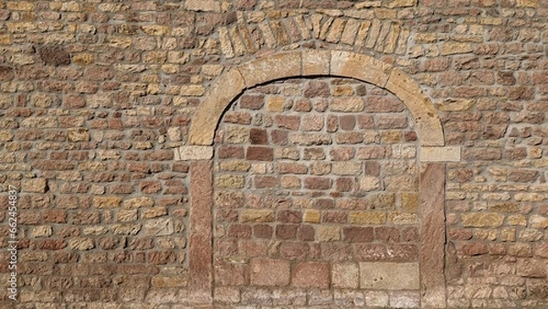 Obraz Historic archway bricked up in a wall which could be used to build a new door.