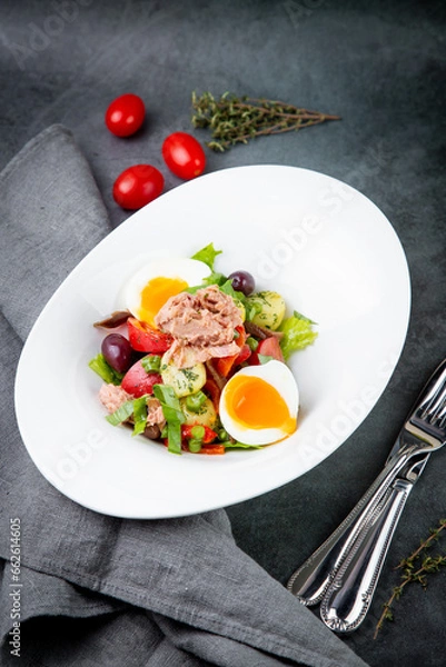 Fototapeta salad with soft-boiled egg, tuna, green onions, boiled potatoes, side view