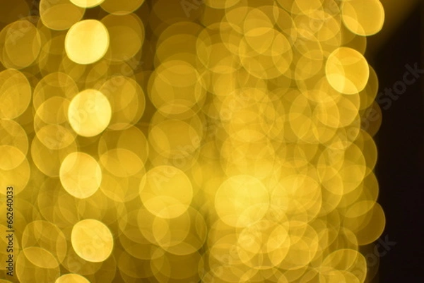 Fototapeta Golden abstract bokeh on black background.