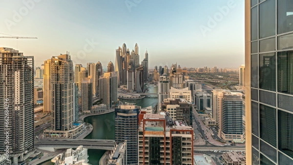 Fototapeta Panorama showing various skyscrapers in tallest recidential block in Dubai Marina aerial timelapse