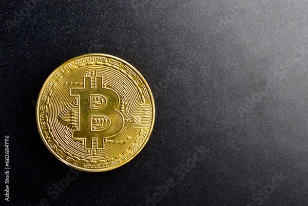 Fototapeta Top view of bitcoin on dark background with text space