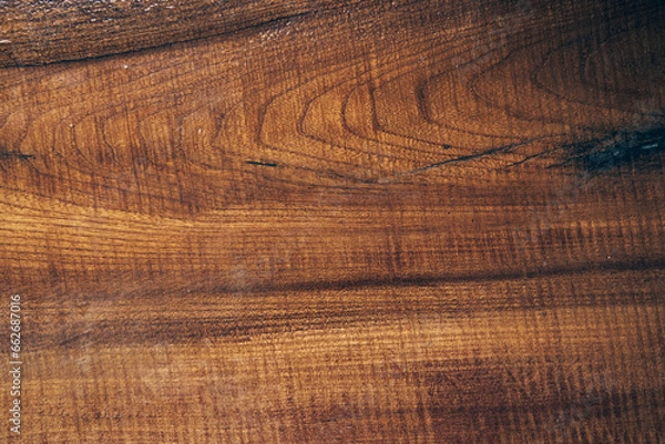 Fototapeta The texture of old light wood with stain and transparent epoxy resin in cracks. Beautiful modern wooden background with resin. High quality photo