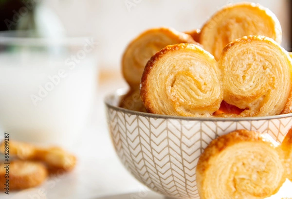 Obraz Close up of Puff pastry palmiers in a bowl on a white marble table. Homemade bakery for breakfast.