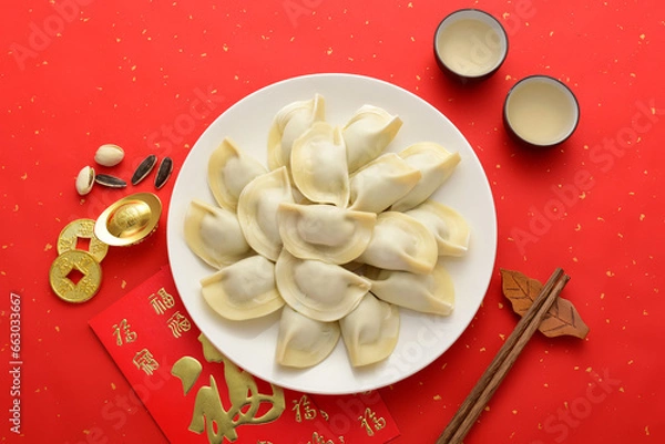 Obraz Delicious dumplings on a red background in China. The Chinese meaning in the picture is: attracting wealth and treasures