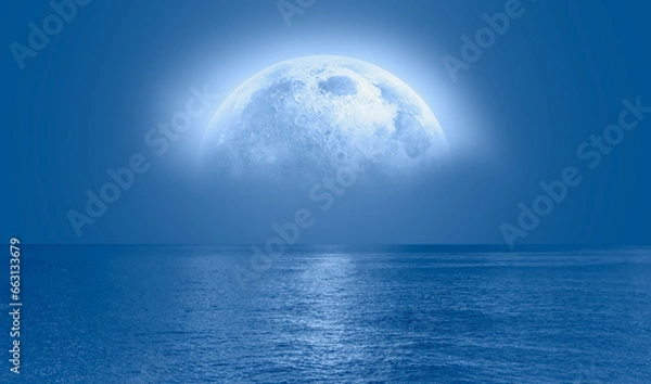 Obraz Night sky with blue moon in the clouds over the calm blue sea, many sytars in the background  "Elements of this image furnished by NASA