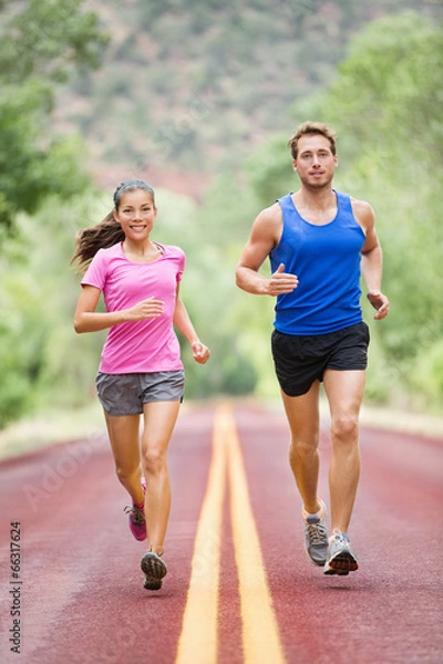 Obraz Running people - two smiling runners jogging
