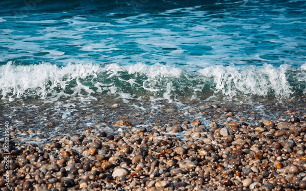 Fototapeta waves and rocks on the beach