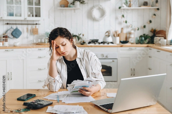 Obraz Stressed caucasian woman trying to deal with financial documents, having problem to find money to pay utility bills or loans. The concept of debt, bankrupt. Accounting companies advertisement mockup