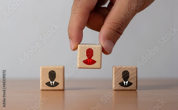 Fototapeta hand choose wood cube block with red businessman icon for human resources management and recruitment business, build team, leadership, outstanding smart person concept