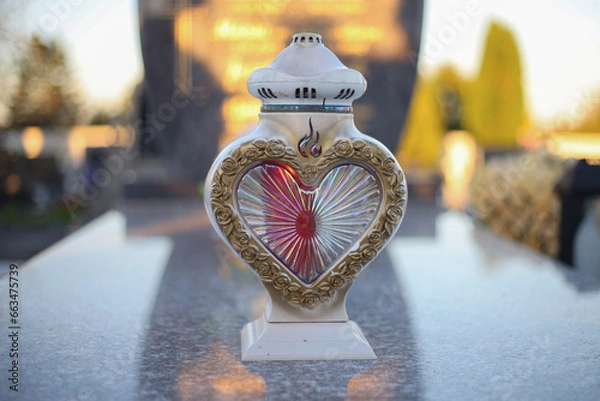 Obraz Close up of Votive candles lantern on the grave in Slovak Catholic cemetery during day. Autumn scene. All Hallows eve. Memorial to the deceased. Solemnity of All Saints. 1st November, All Saints' Day