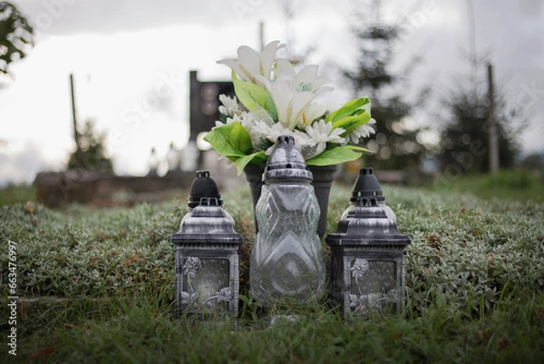 Obraz Close up of Votive candles lantern on the grave in Slovak Catholic cemetery during day. Autumn scene. All Hallows eve. Memorial to the deceased. Solemnity of All Saints. 1st November, All Saints' Day
