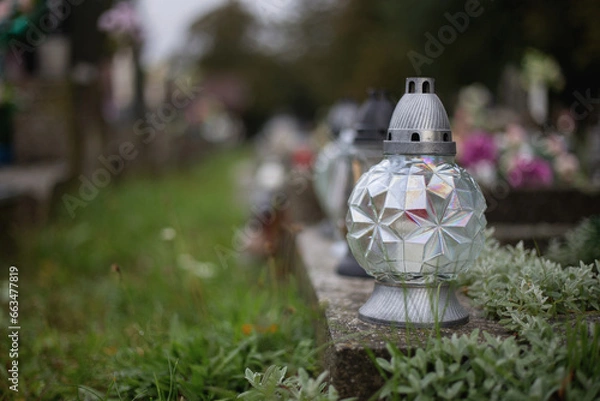 Obraz Close up of Votive candles lantern on the grave in Slovak Catholic cemetery during day. Autumn scene. All Hallows eve. Memorial to the deceased. Solemnity of All Saints. 1st November, All Saints' Day