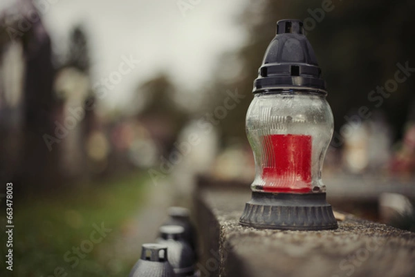 Obraz Close up of Votive candles lantern on the grave in Slovak Catholic cemetery during day. Autumn scene. All Hallows eve. Memorial to the deceased. Solemnity of All Saints. 1st November, All Saints' Day
