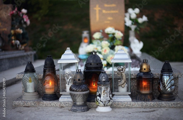 Obraz Close up of Votive candles lantern on the grave in Slovak Catholic cemetery during day. Autumn scene. All Hallows eve. Memorial to the deceased. Solemnity of All Saints. 1st November, All Saints' Day