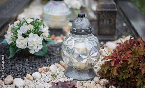 Obraz Close up of Votive candles lantern on the grave in Slovak Catholic cemetery during day. Autumn scene. All Hallows eve. Memorial to the deceased. Solemnity of All Saints. 1st November, All Saints' Day