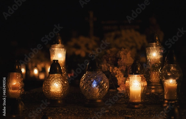 Obraz Votive candles lantern burning on the graves in Slovak cemetery at night time. All Saints' Day. Solemnity of All Saints. Hallows eve. 1st November. Feast of Saints. Hallowmas. Souls' Day in Slovakia