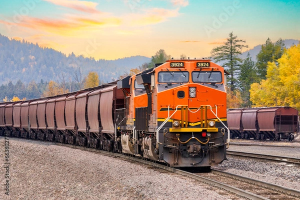 Obraz freight train in autumn with a beautiful sunset sky close to Whitefish, Montana