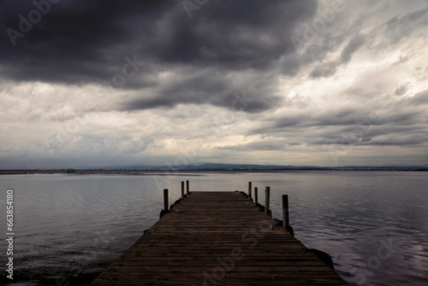 Obraz play of lights with the clouds over the Albufera pier