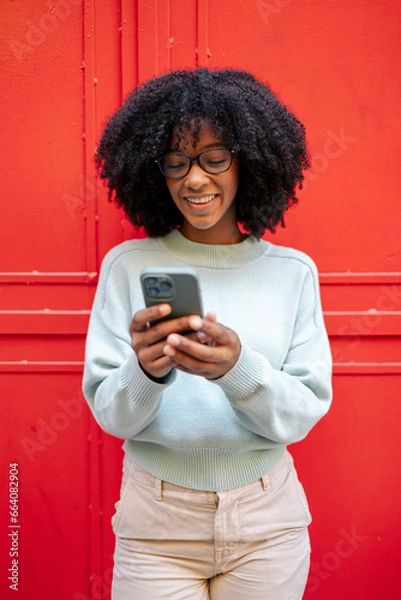 Obraz Portrait of african-american girl with smartphone