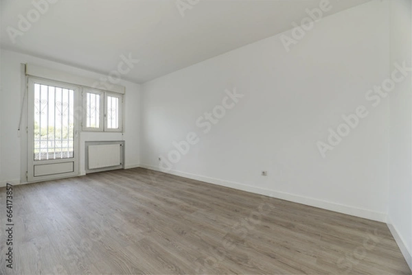 Fototapeta Large empty bedroom of a single-family residential home with access to a terrace with a white aluminum and glass door