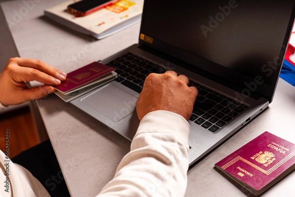 Obraz Working in the office manipulating passports. Computer, keyboard, mouse