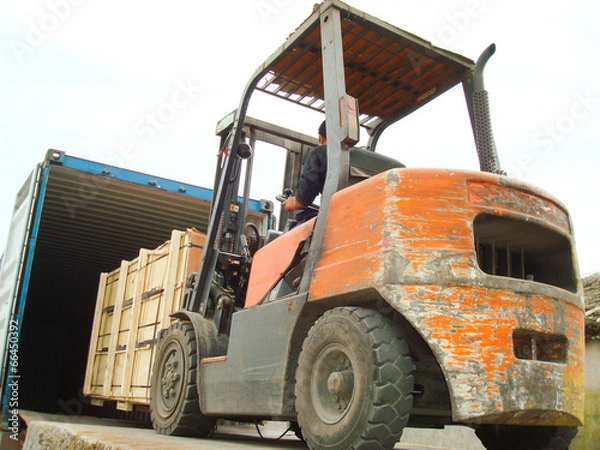 Obraz Electric Forklift Loading Cargos into Container