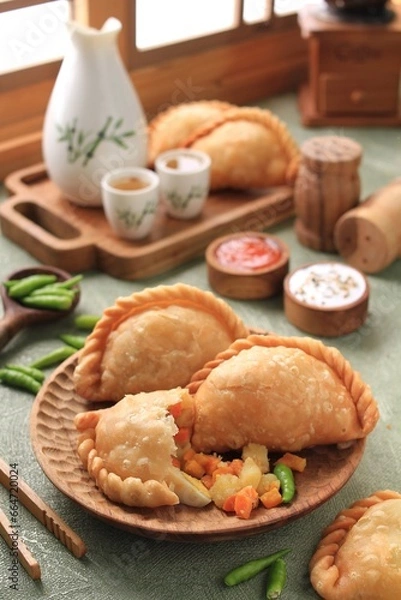 Fototapeta Jalangkote  is a South Sulawesi fried dumpling from Indonesian cuisine, stuffed with rice vermicelli, vegetables, potatoes and eggs. Spicy, sweet and sour sauce will be dipped into prior to be eaten. 