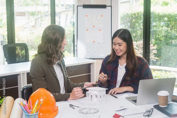 Obraz Architectural woman designer making digital building plan for professional construction renovation in office.