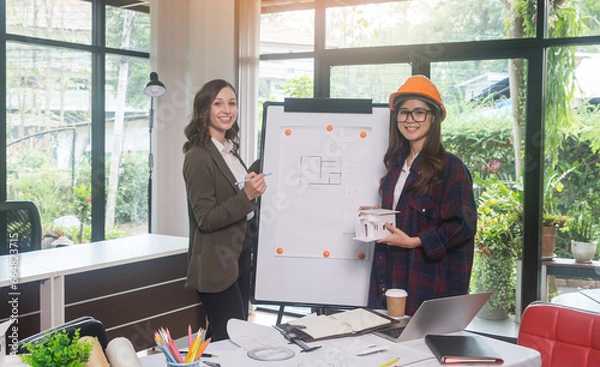 Fototapeta Architectural woman designer making digital building plan for professional construction renovation in office.