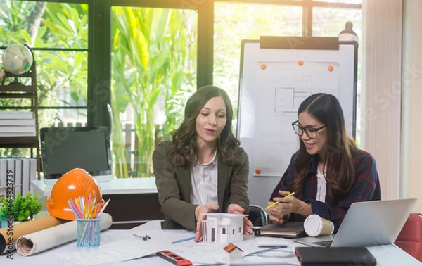 Obraz Architectural woman designer making digital building plan for professional construction renovation in office.