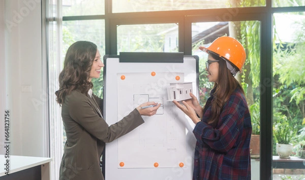 Obraz Architectural woman designer making digital building plan for professional construction renovation in office.