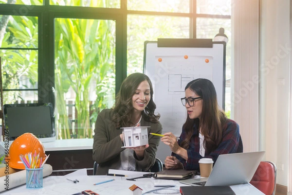 Obraz Architectural woman designer making digital building plan for professional construction renovation in office.