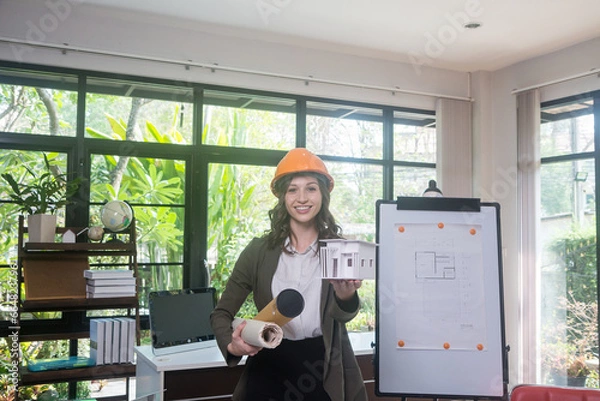 Obraz Architectural woman designer making digital building plan for professional construction renovation in office.