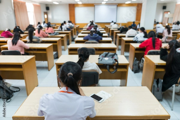 Fototapeta Selective focus high school or university students concentrate on language listening test in the examination hall