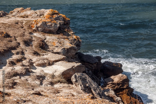 Fototapeta The waves break on the rocks. Rocky shore. The coastline. The power of the elements. The raging sea.